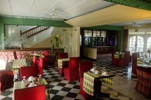 Enjoy meals in a stylish dining area with checkered floors and comfortable seating.