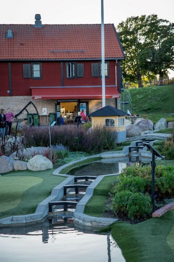 Guests can enjoy a tranquil garden with a water feature and a paved path leading to the entrance.