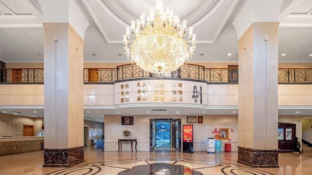A spacious lobby with a grand chandelier, marble flooring, and a reception desk. - WEISELECT MengZi Tian Yuan Hotel (Honghe)