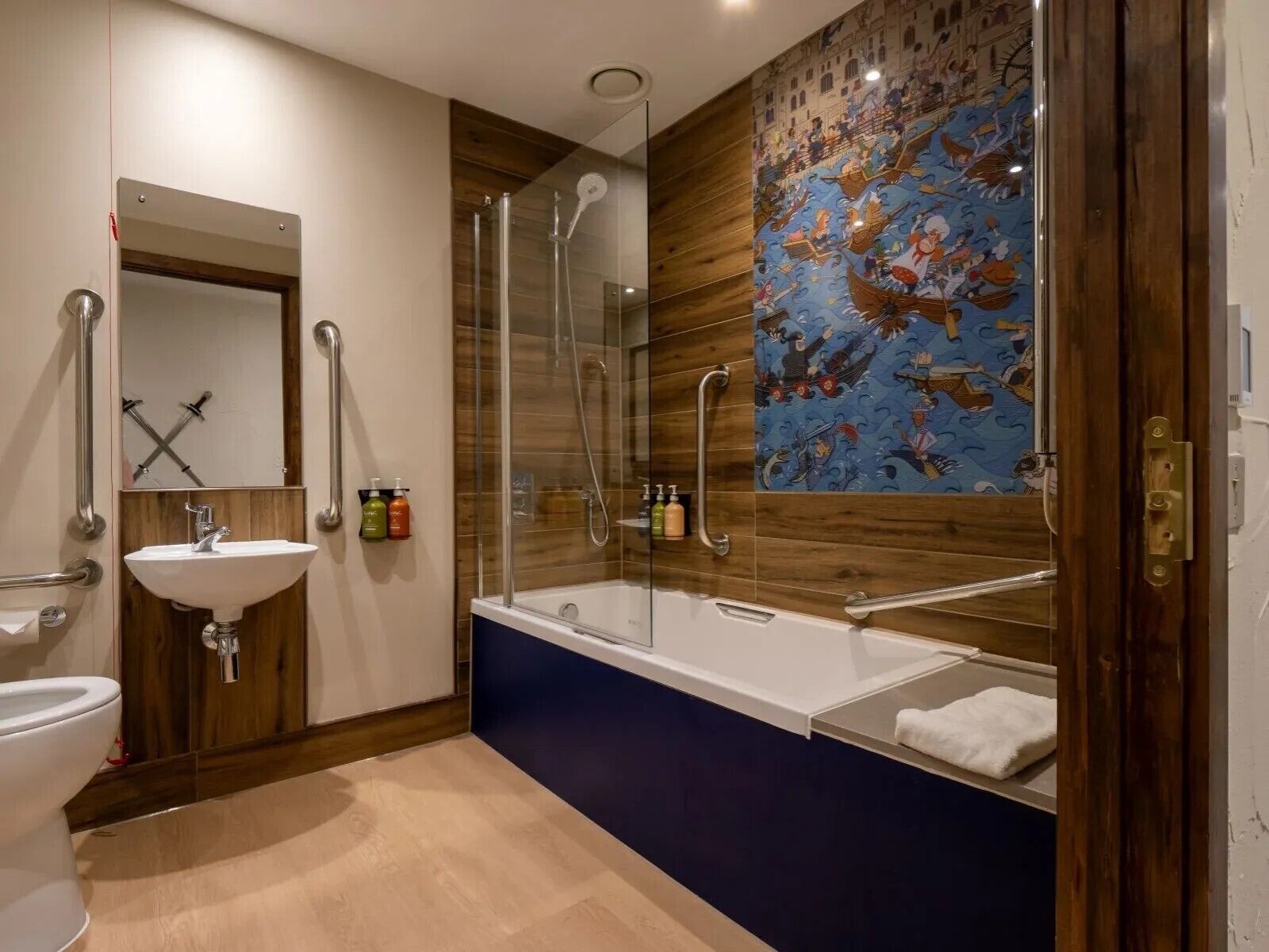 A modern bathroom with a glass-enclosed shower, a white sink, and a bathtub.
