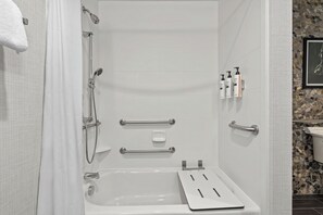 A modern bathroom with a bathtub, shower, and handrails. - Hilton Garden Inn Nashville Brentwood (Brentwood)