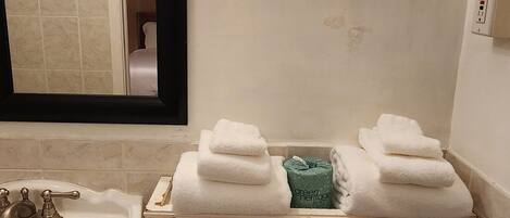 Un baño con lavamanos, inodoro y perchero para toallas.