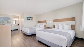 A hotel room with two beds, a desk, and a bathroom. - The Atwood Hotel San Diego - SeaWorld/Zoo (San Diego)
