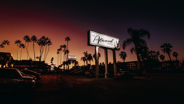 A hotel sign with palm trees in the background. - The Atwood Hotel San Diego - SeaWorld/Zoo (San Diego)