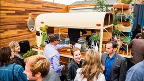 A group of people gathered around a food truck with a wooden wall backdrop. - The Atwood Hotel San Diego - SeaWorld/Zoo (San Diego)