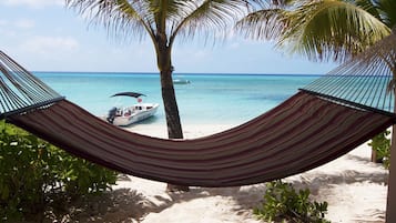 On the beach, white sand, sun loungers, beach umbrellas