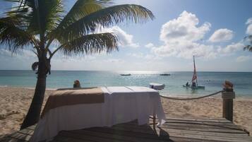 On the beach, white sand, sun-loungers, beach umbrellas