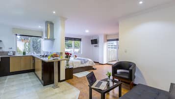 A modern apartment with a kitchen, dining area, and living room.