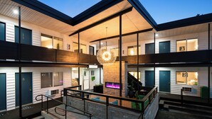A modern building with multiple floors, a central lobby, and a staircase. - Hotel McCoy Pullman - Art, Coffee, Beer, Wine (Pullman)