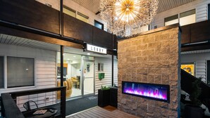 A lobby with a fireplace, a sign reading "Lobby", and a staircase. - Hotel McCoy Pullman - Art, Coffee, Beer, Wine (Pullman)