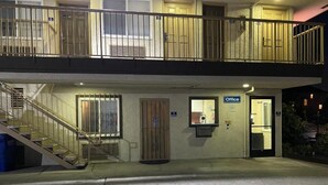 A two-story building with a ground-floor office and a staircase leading to the upper floor. - Bayview Motel (Emeryville)