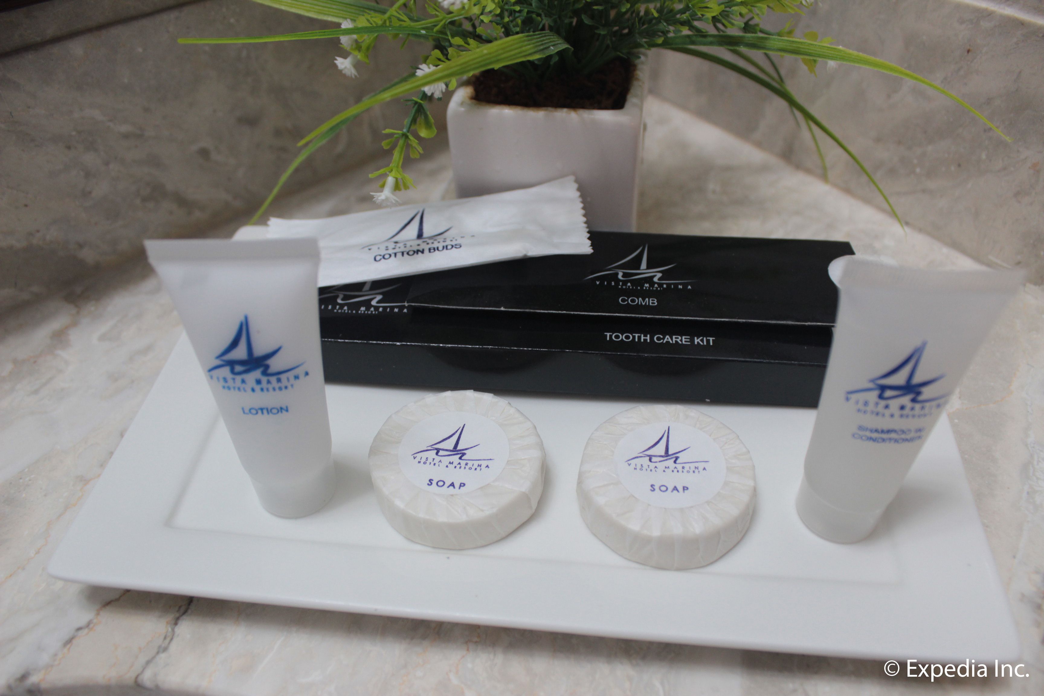 A tray with toiletries including a toothbrush, toothpaste, and soap.