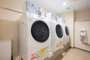 A row of front-loading washing machines in a commercial setting. - Richmond Hotel Namba Daikokucho (Osaka)