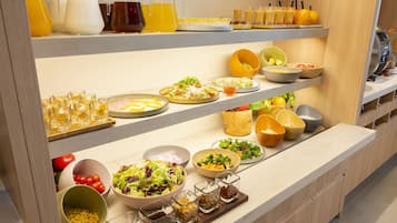 A buffet with various food items and beverages.