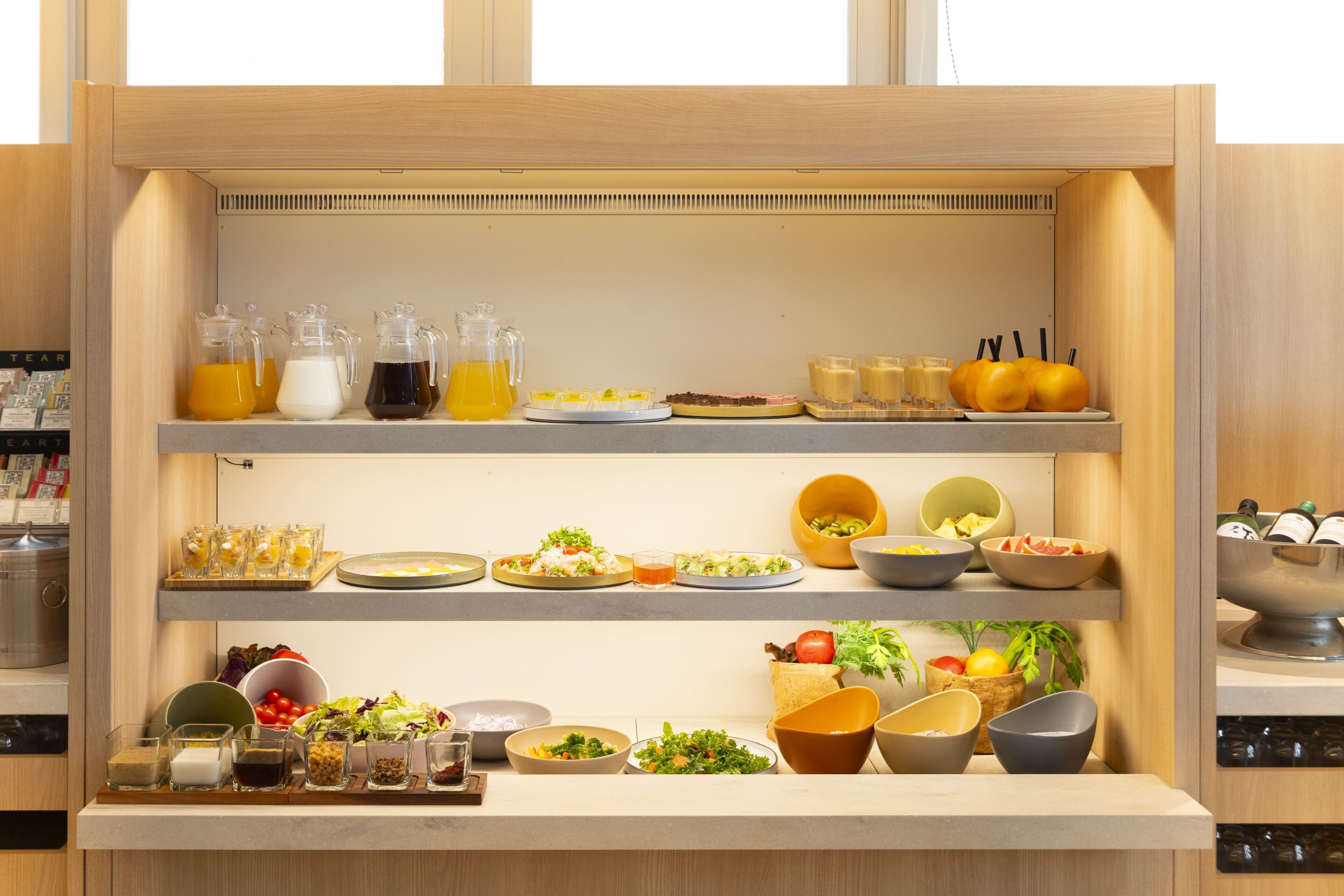 A buffet setup with various food items and beverages.