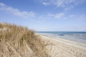 On the beach, white sand, sun-loungers, beach umbrellas