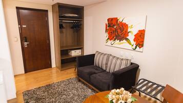 Premium Suite, 1 King Bed | Living area | 32-inch LCD TV with cable channels, TV