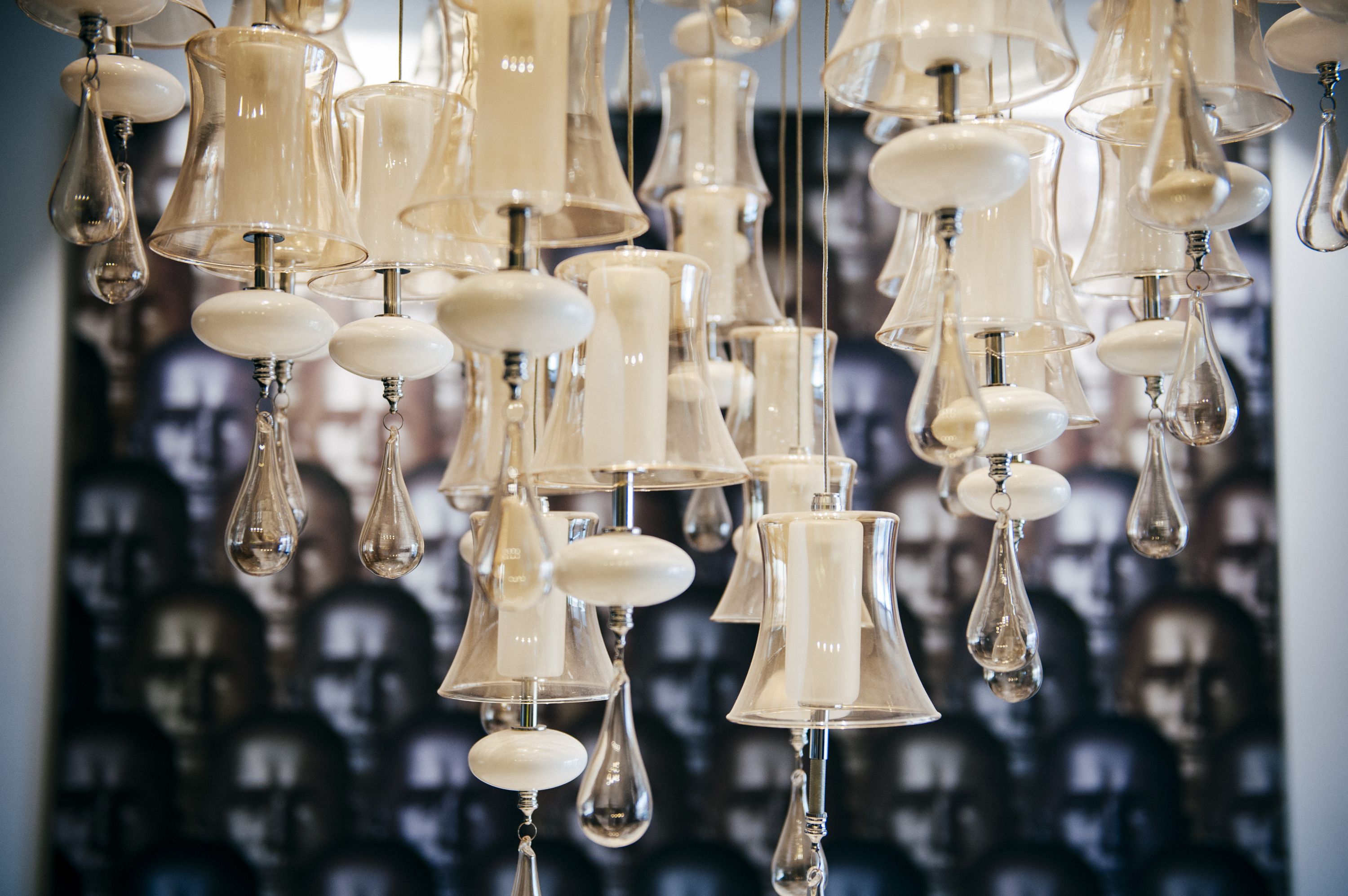 A chandelier with multiple light bulbs and white fixtures.