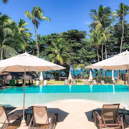 Outdoor pool, pool umbrellas, sun loungers. Iara Beach Hotel