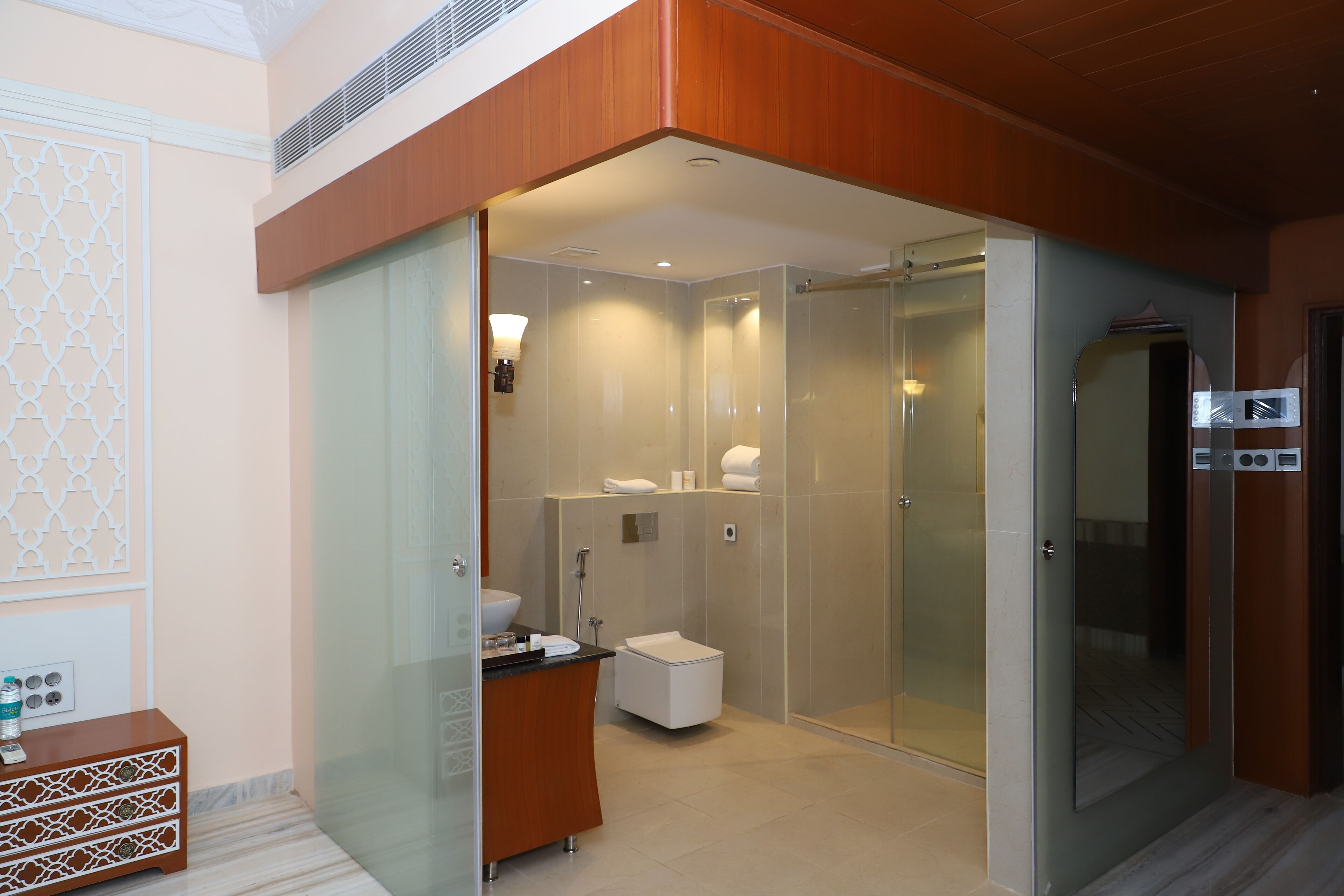 Un bagno moderno con cabina doccia in vetro, un WC separato e un mobile lavabo.