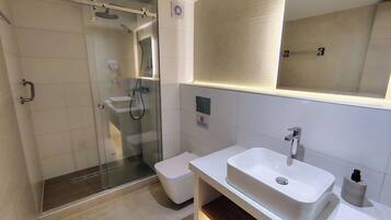 Habitación triple Deluxe | Baño | Ducha y cabezal de ducha tipo lluvia