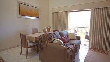 Junior Suite | Living area | 50-inch flat-screen TV with satellite channels, TV, heated floors