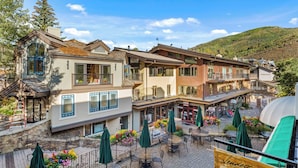 A hotel with outdoor seating, a bar, and a restaurant. - Christiania Condominiums - Residence Collection (Vail)