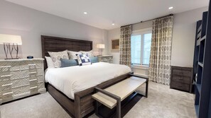 A modern hotel bedroom with a large bed, bedside tables, a bench, and a view of the city. - Christiania Condos - CoralTree Residence Collection (Vail)