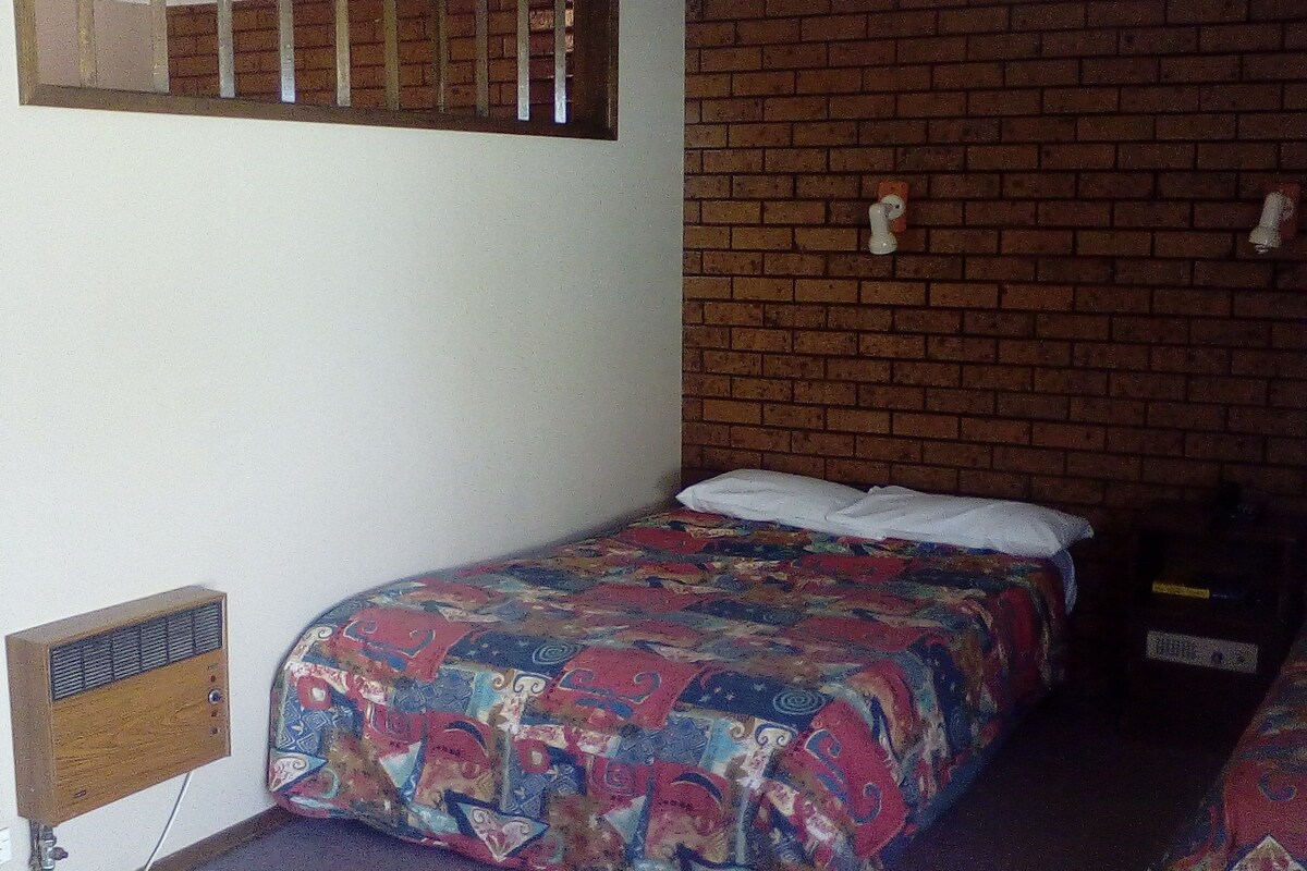 Family Room | Desk, iron/ironing board, bed sheets