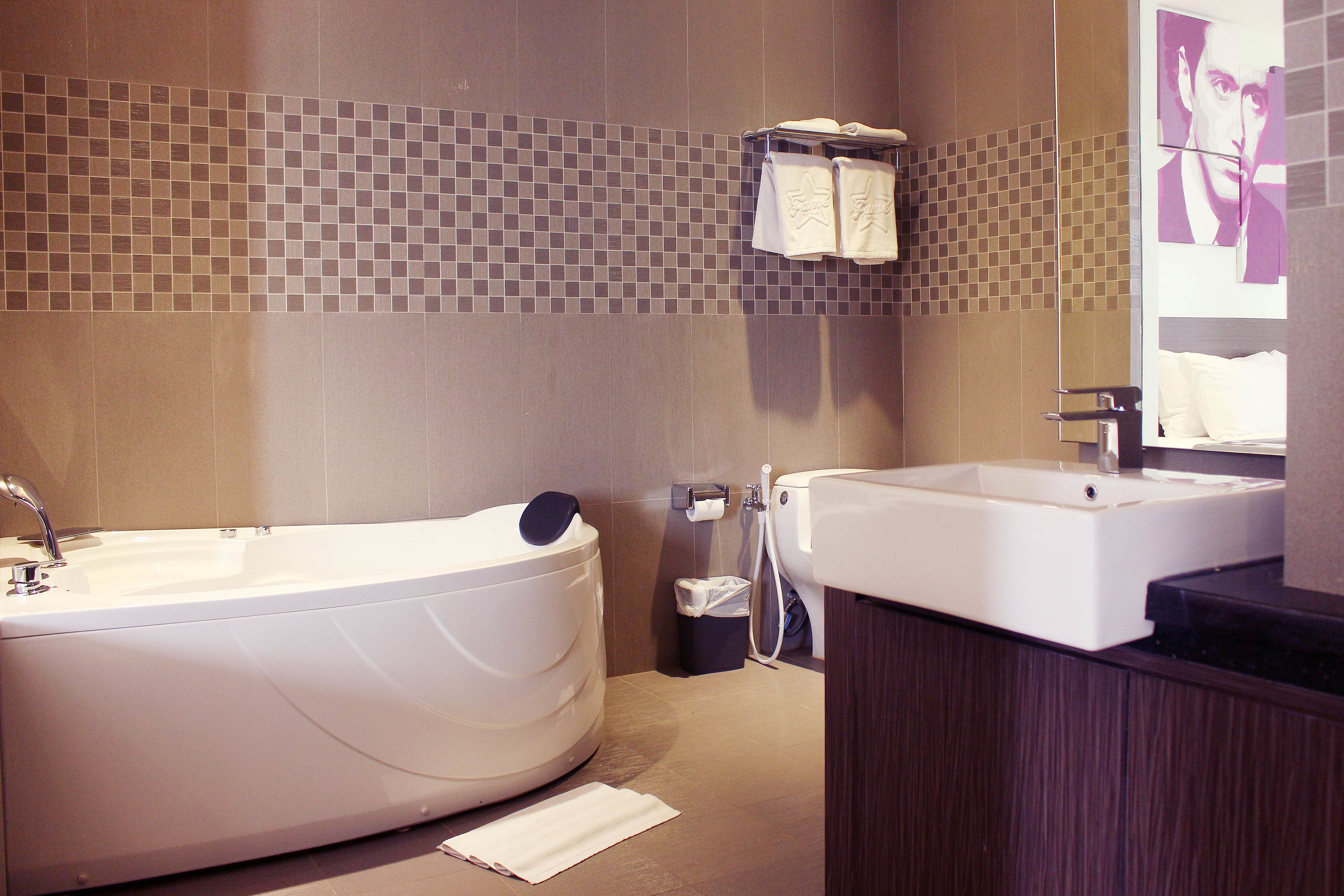 A modern bathroom with a freestanding bathtub, a sink, and a mirror.