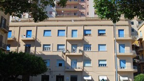 A multi-story residential building with balconies, windows, and a visible entrance. - B&B La finestra sulla valle (Agrigento)