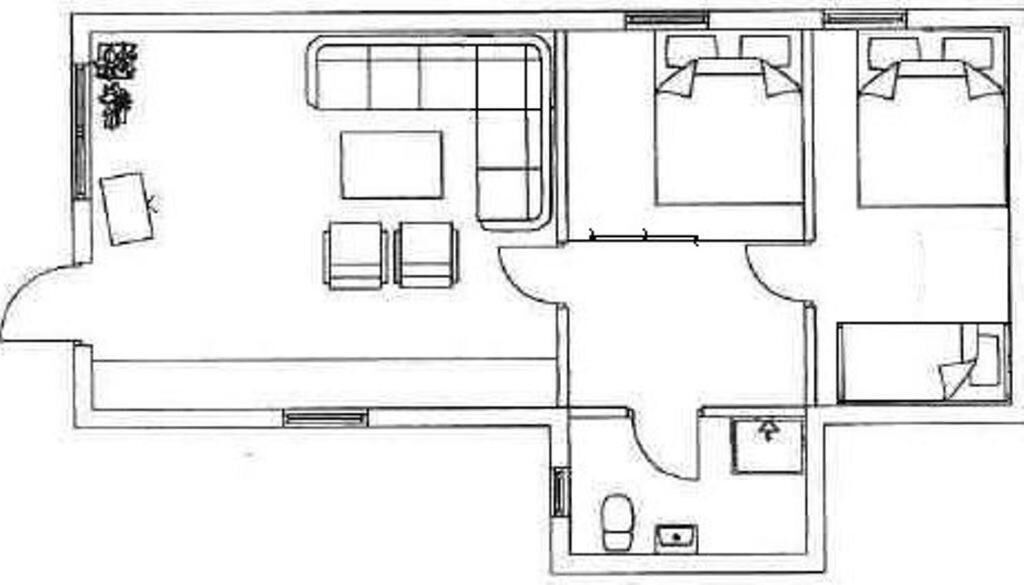 A floor plan with a living area, two bedrooms, a bathroom, and a kitchen.