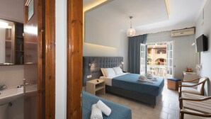 A hotel room with two beds, a bathroom, a TV, and a balcony with a view. - Alkion Hotel Sidari (Corfu)