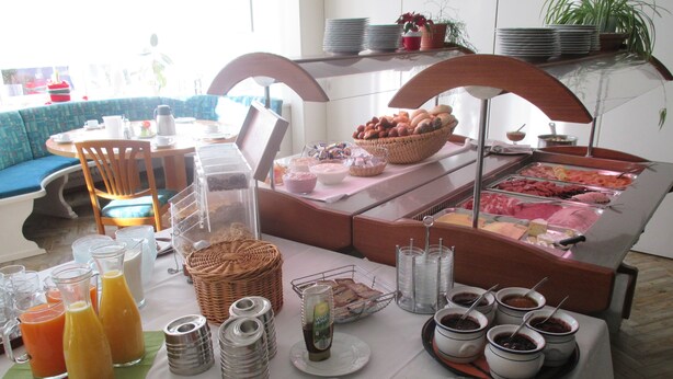 A buffet setup with various food items, beverages, and condiments. - Landhotel zur Linde (Lossburg)