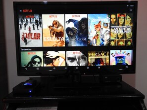 A television displaying a Netflix interface with various movie thumbnails. - Hostal Don Miguel Cartagena de Indias (Cartagena)