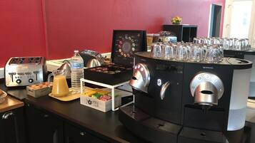 A coffee station with a coffee machine, a toaster, and a water dispenser.
