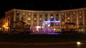 A large, historic building with a central fountain, surrounded by well-maintained gardens. - ABC Hôtel (Toul)