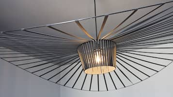 A modern ceiling with a radial design and a central light fixture.