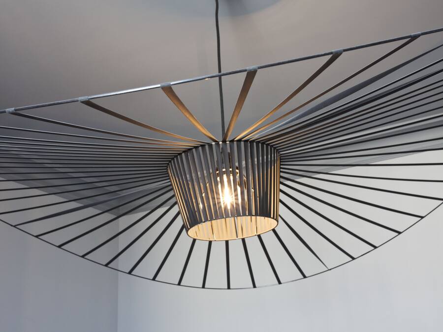A modern ceiling with a radial design and a central light fixture.