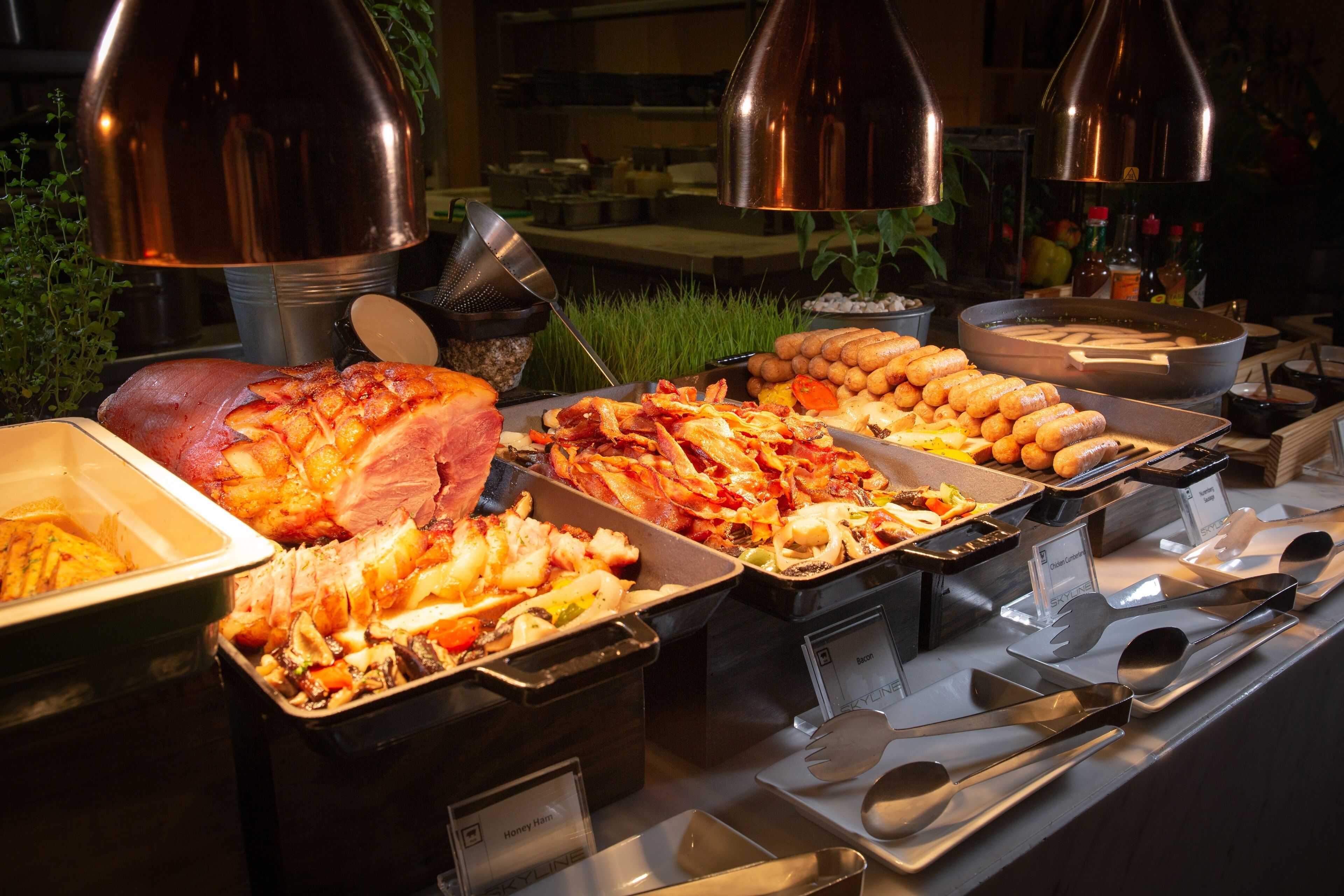 A buffet with various food items and serving utensils.