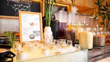 A buffet with various food items and a sign detailing the health benefits of almond milk and homemade yogurt.