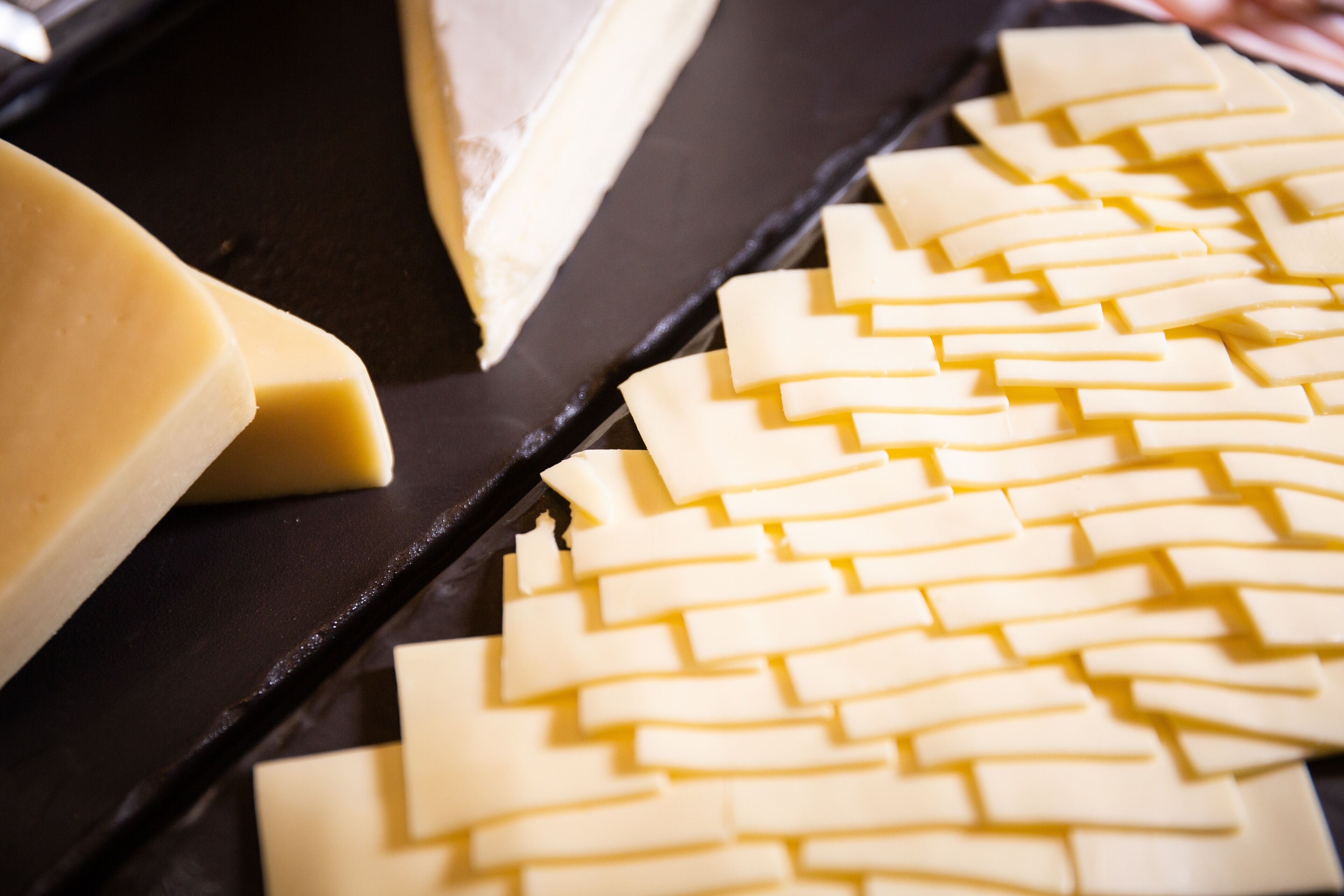 A cheese board with various types of cheese and crackers.