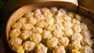 A bamboo steamer filled with dumplings.