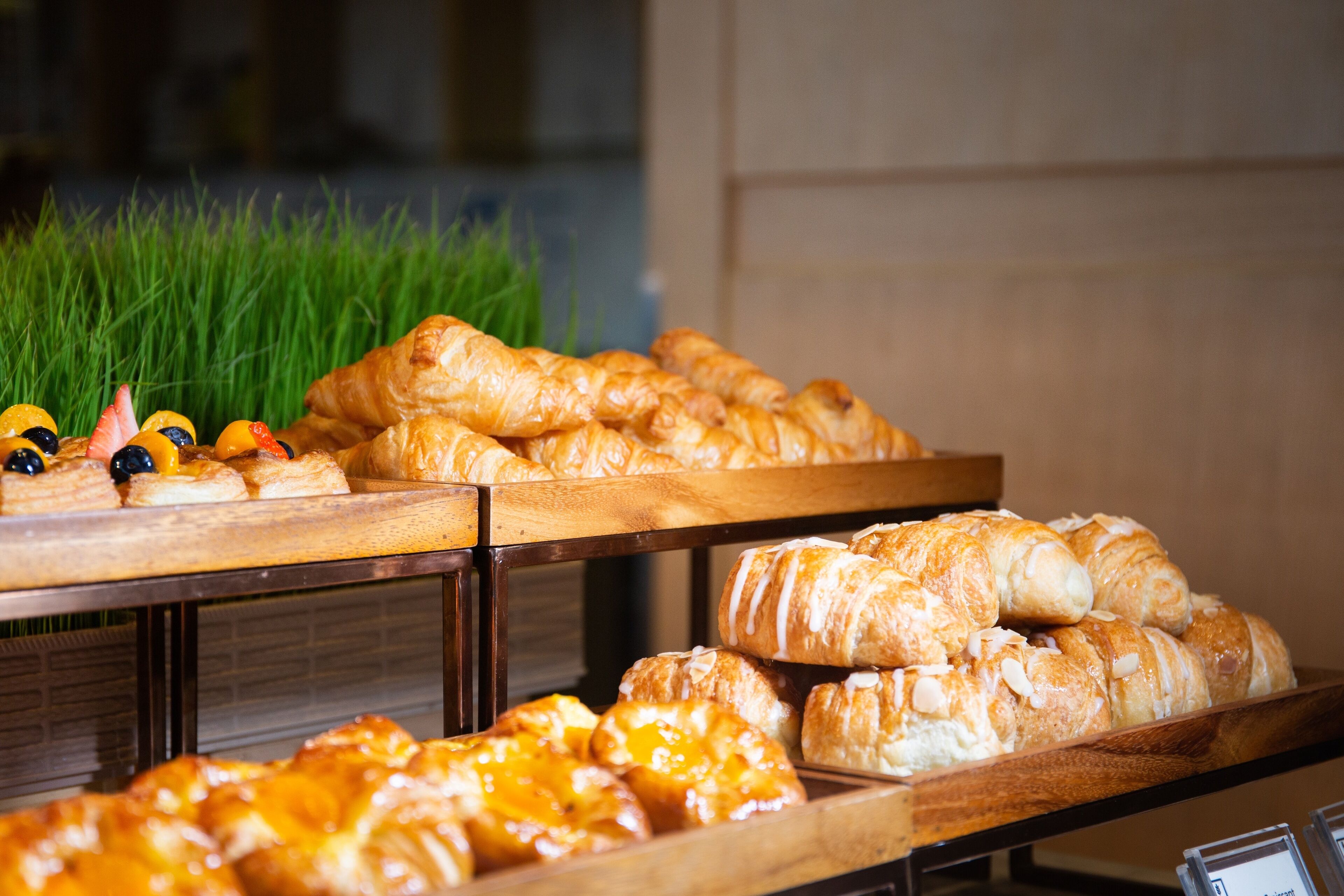A variety of pastries displayed on wooden trays.