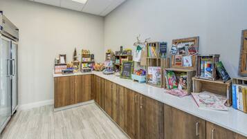 A reception area with a counter displaying various items like books, magazines, and stationery.