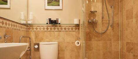A modern bathroom with a glass-enclosed shower, a sink, and a toilet.