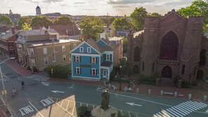 A blue building with a sign reading "Stepping Stone Inn" in a town with historic architecture.
