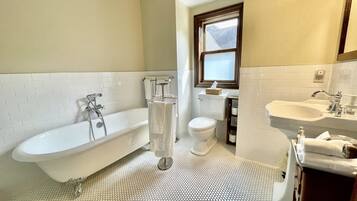 Un baño con bañera, inodoro y lavamanos.
