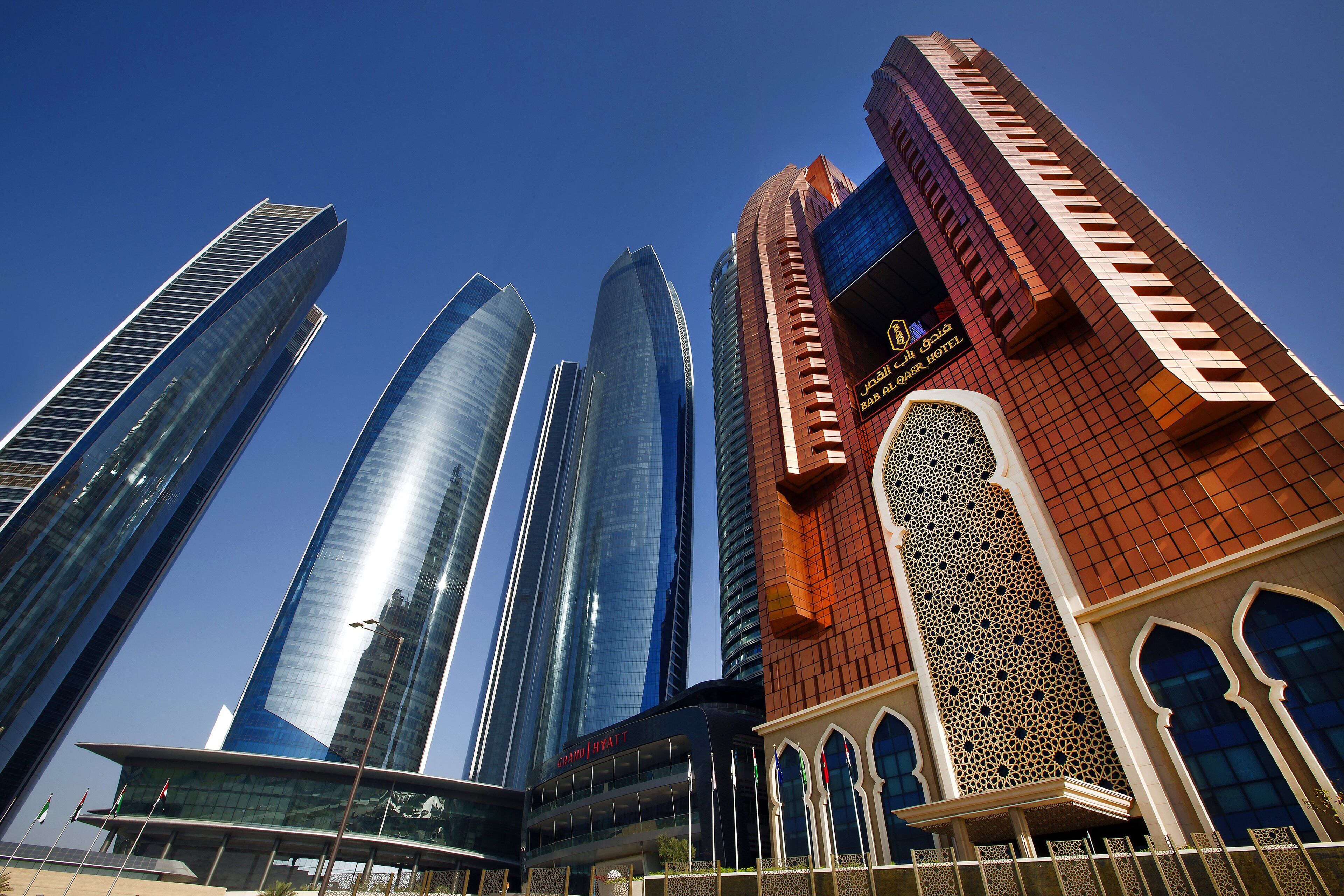 A modern hotel with a distinctive red facade and traditional architectural elements.