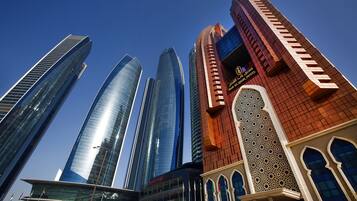 A modern hotel with a distinctive red facade and traditional architectural elements.